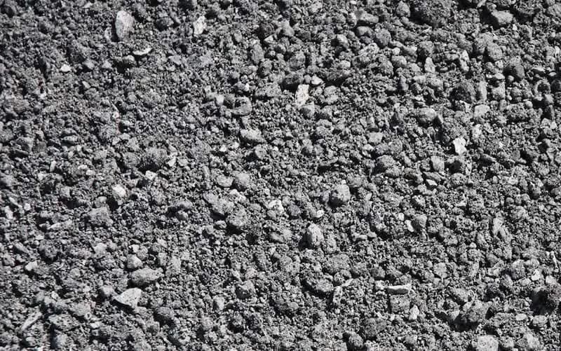 Gray stone screenings with a fine gravel texture.